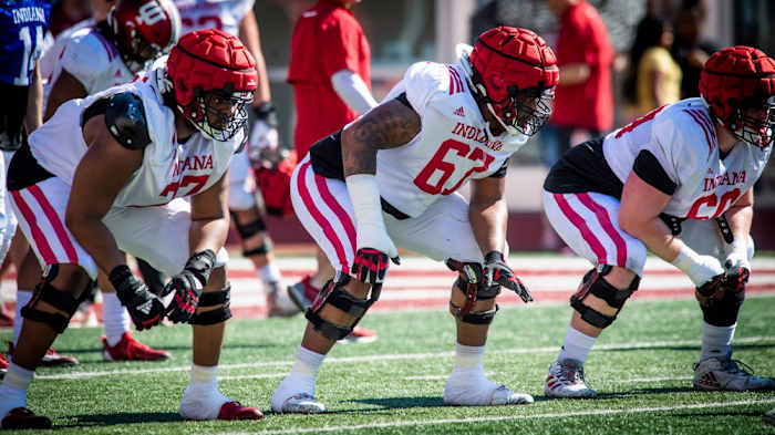Indiana linemen Joshua Sales Jr. (77), Kalil Benson (67) and Max Longman (60) prepare for a snap during Indiana football's Spring Football Saturday event at Memorial Stadium on Saturday, April 15, 2203.
